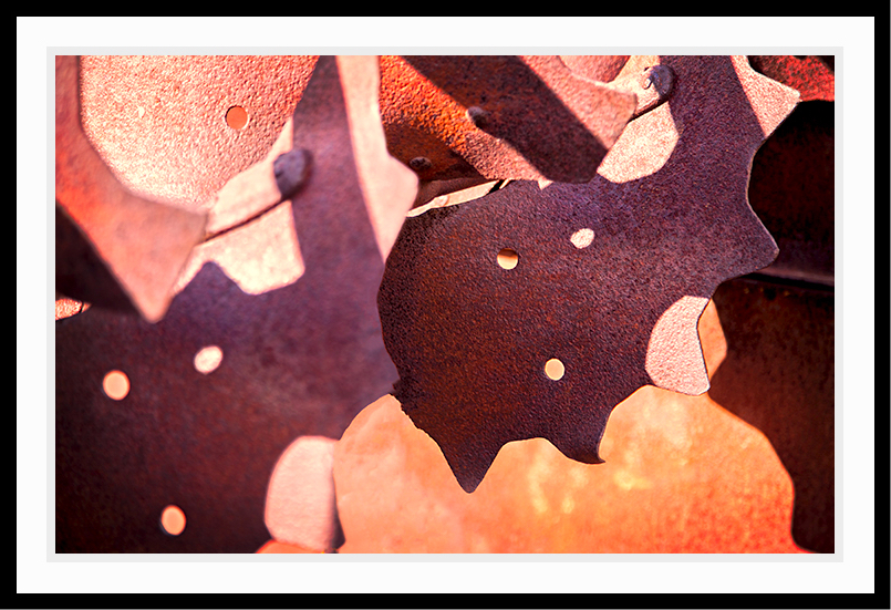 More rusted metal with jagged cutouts.
